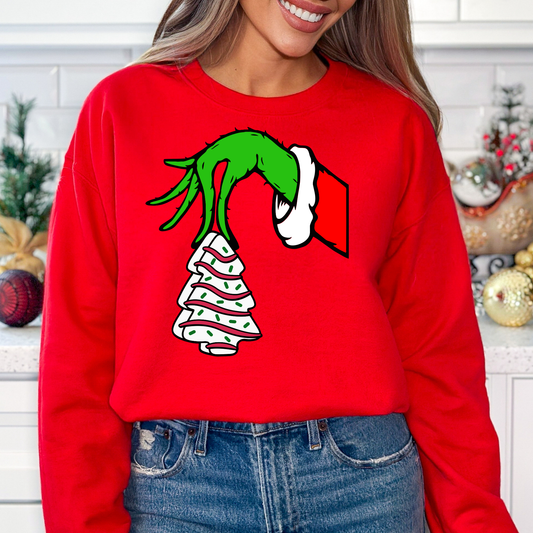 Christmas tree cake with grinch hand